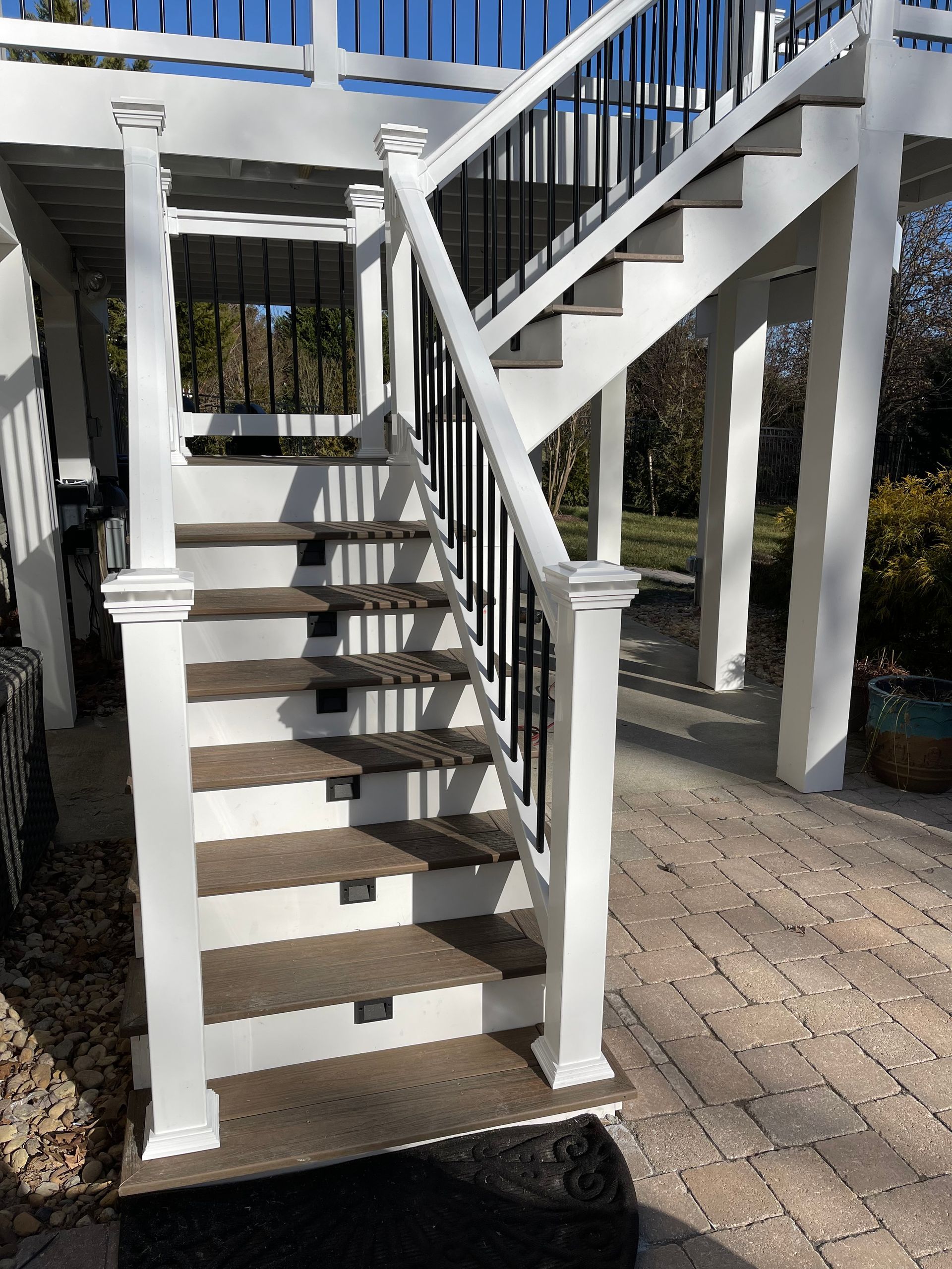A set of stairs leading up to a deck with a blue railing.