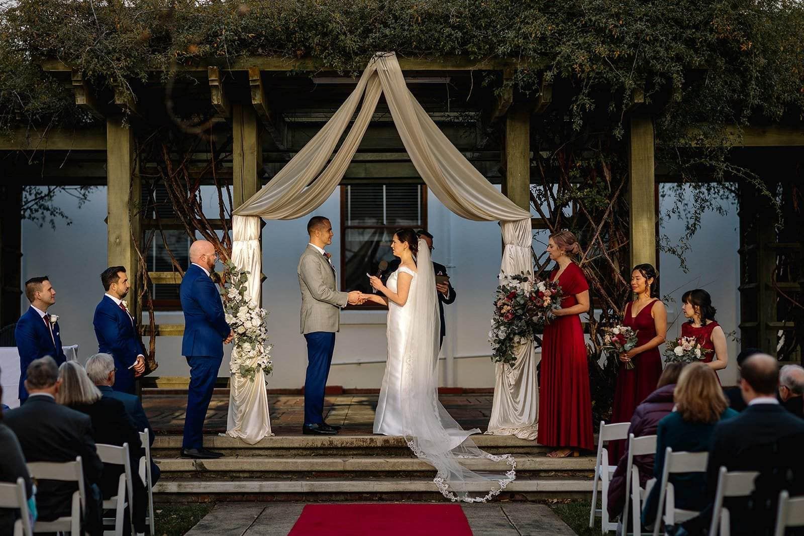 A bride and groom are holding hands in the platform