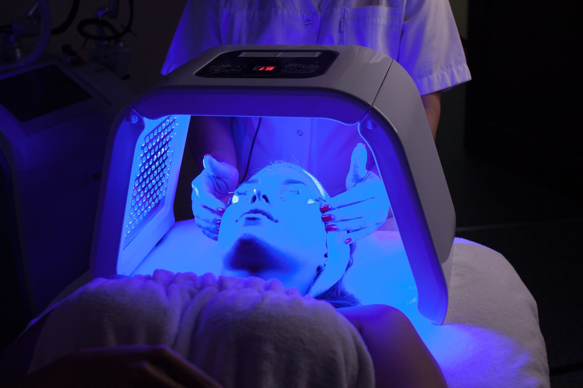 Person Receiving Blue Light Therapy Treatment at a Clinic — Embrace Cosmetic Clinic in Bundaberg North, QLD