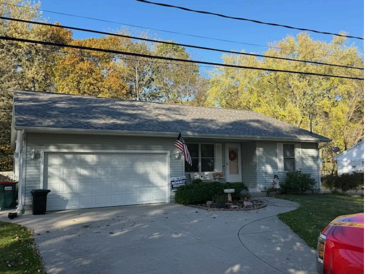 A large house with a brown roof and a large window.