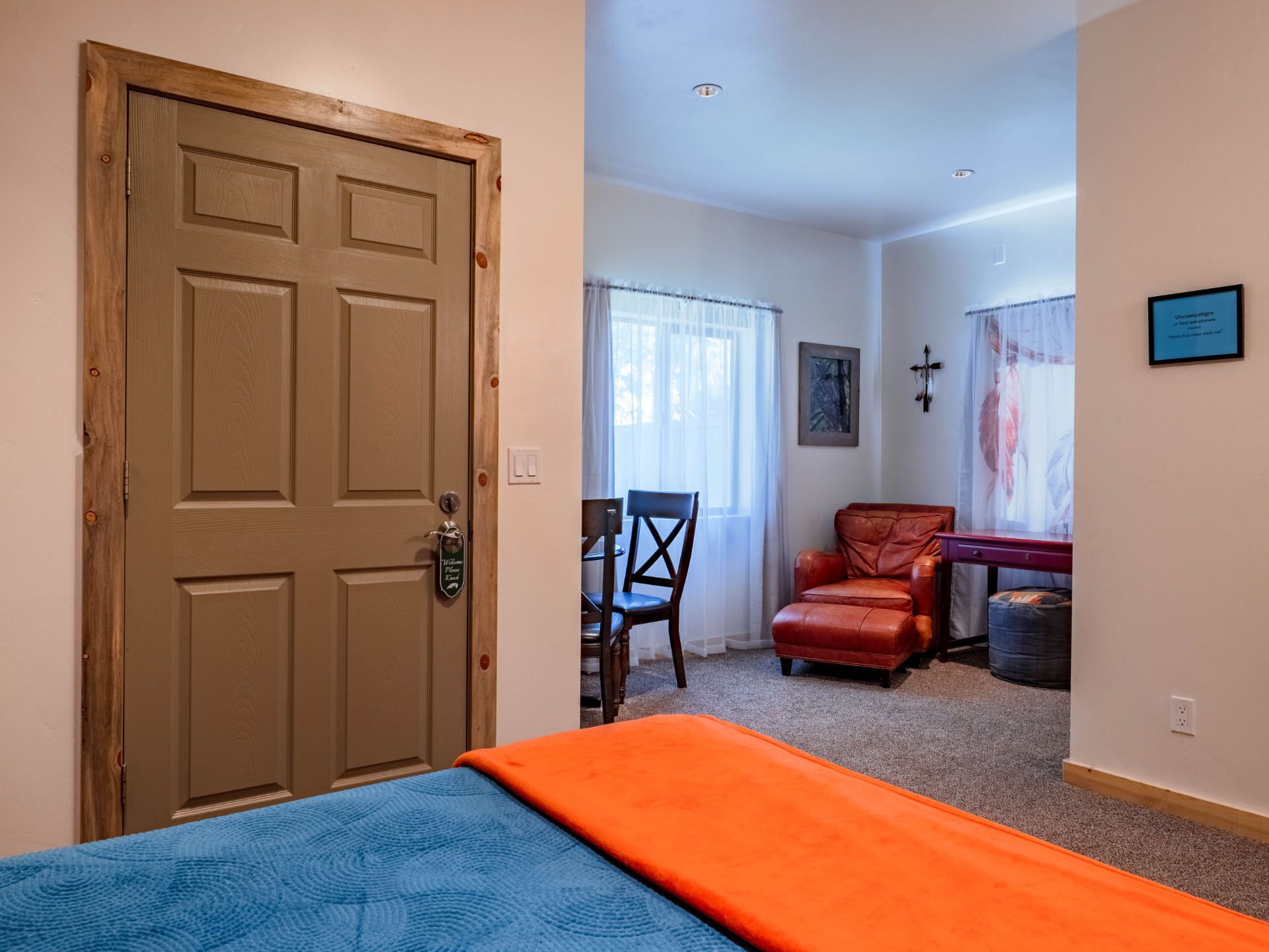 A bedroom with a bed , chair , desk and window.