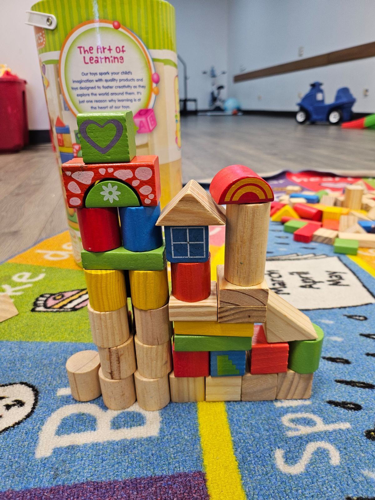 A bunch of wooden blocks are stacked on top of each other on a rug.