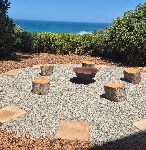 A fire pit in the middle of a gravel area
