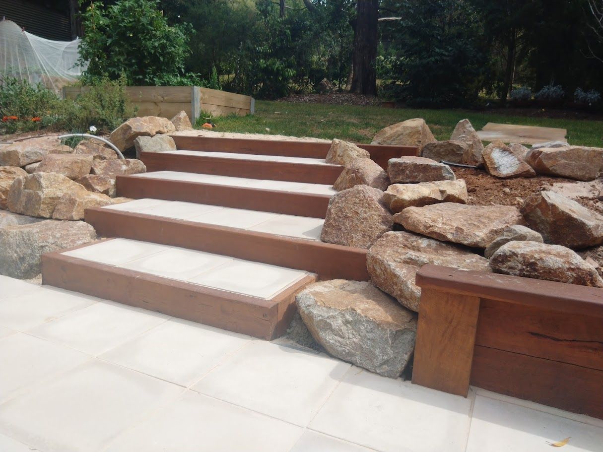A set of stairs surrounded by rocks in a garden
