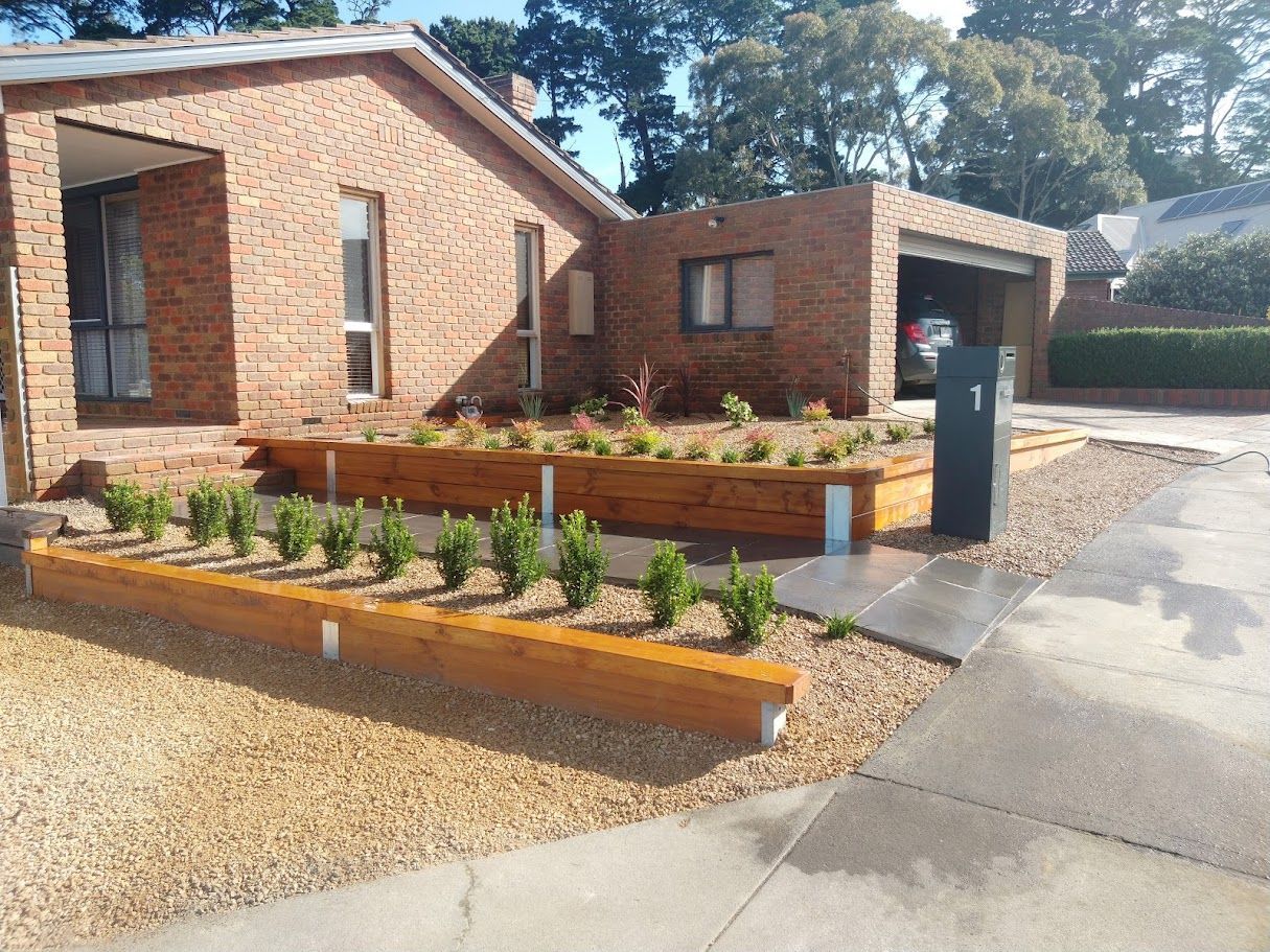 A brick house with a driveway and a mailbox in front of it