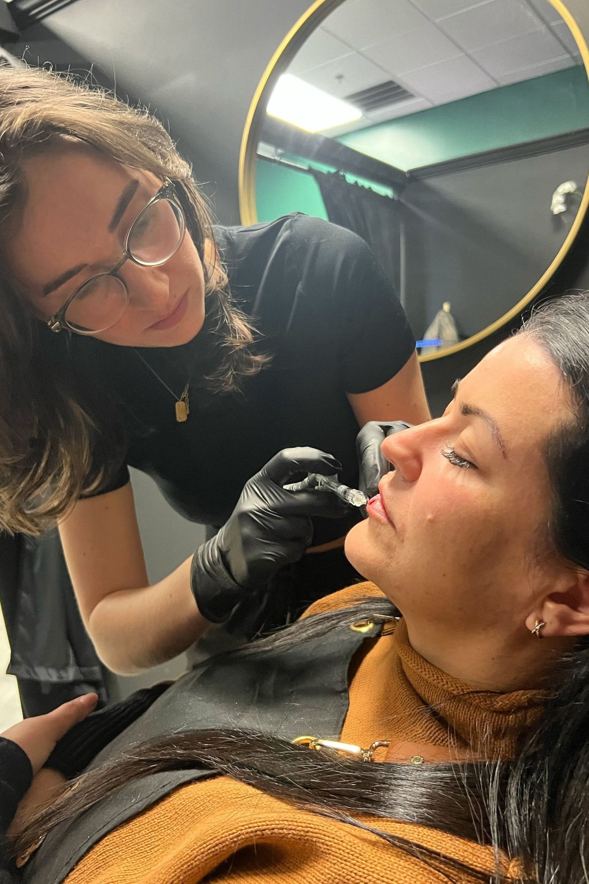 A woman is getting a nose piercing in a beauty salon.