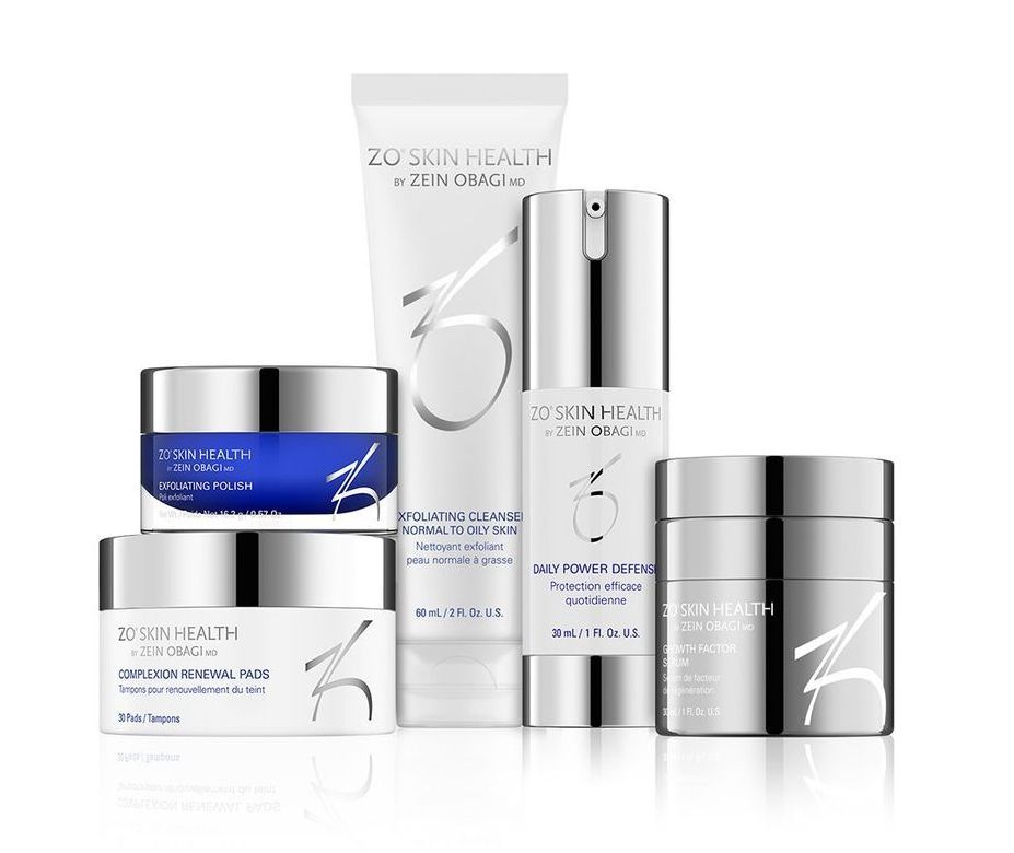 A group of cosmetic products sitting on top of each other on a white surface.