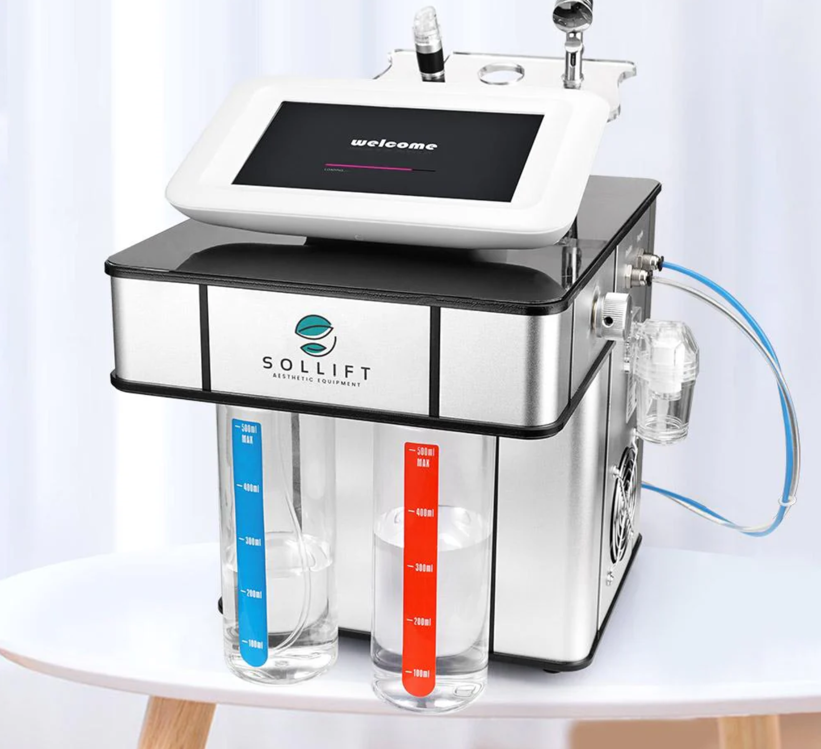 A machine with two measuring cups attached to it is sitting on a table.