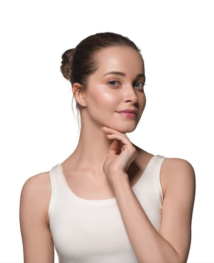 The woman is smiling and holding her hand to her face.