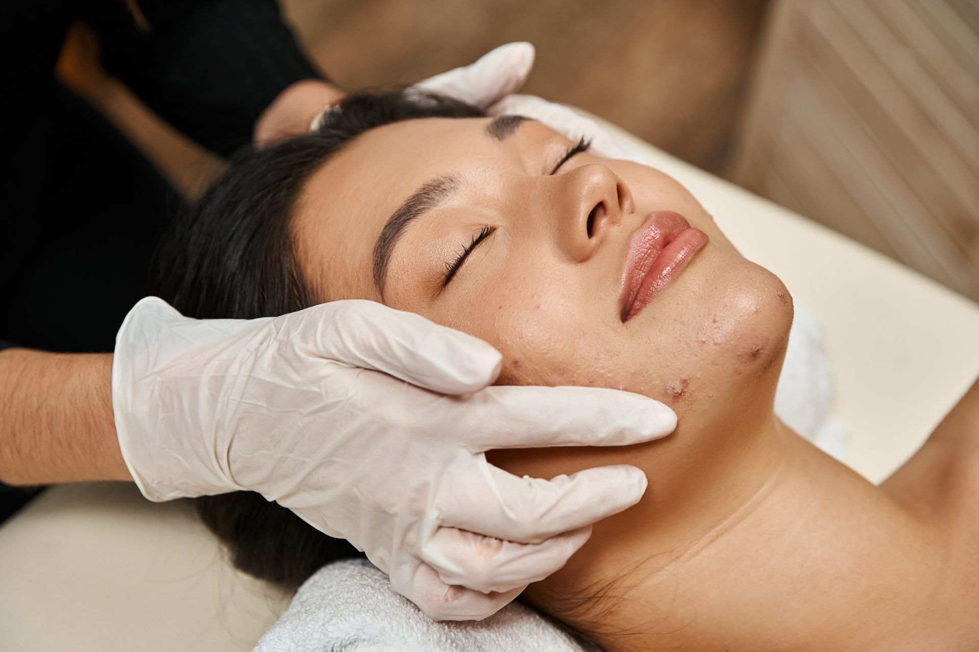 A woman is getting a facial treatment at a spa.