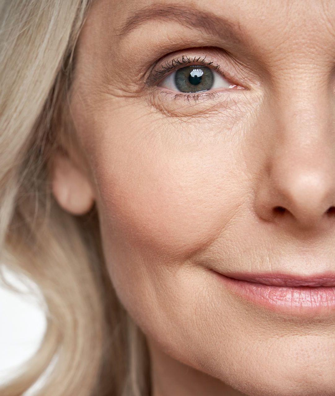 A close up of a woman 's face with a smile on her face.