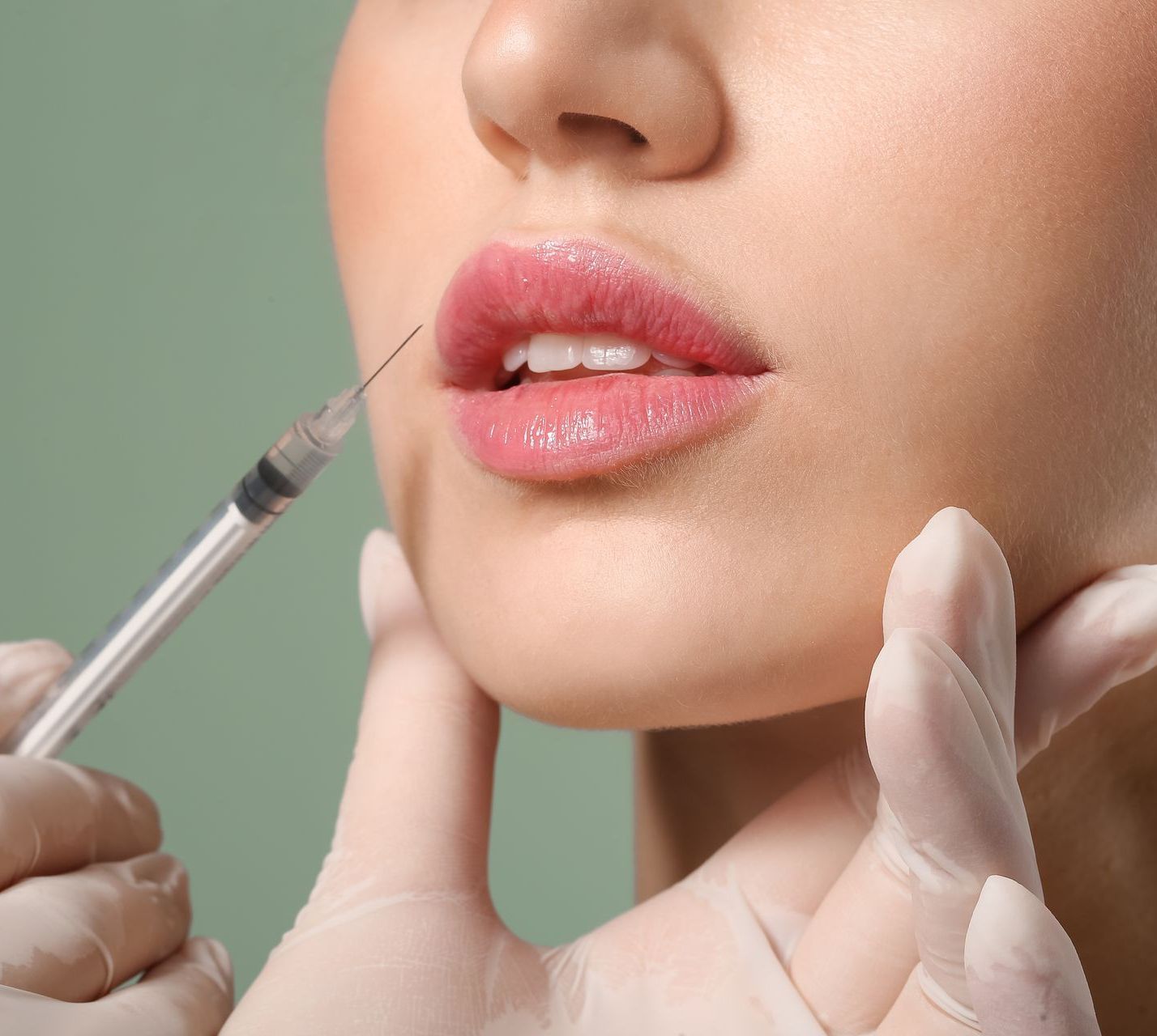 A woman is getting a botox injection in her mouth.