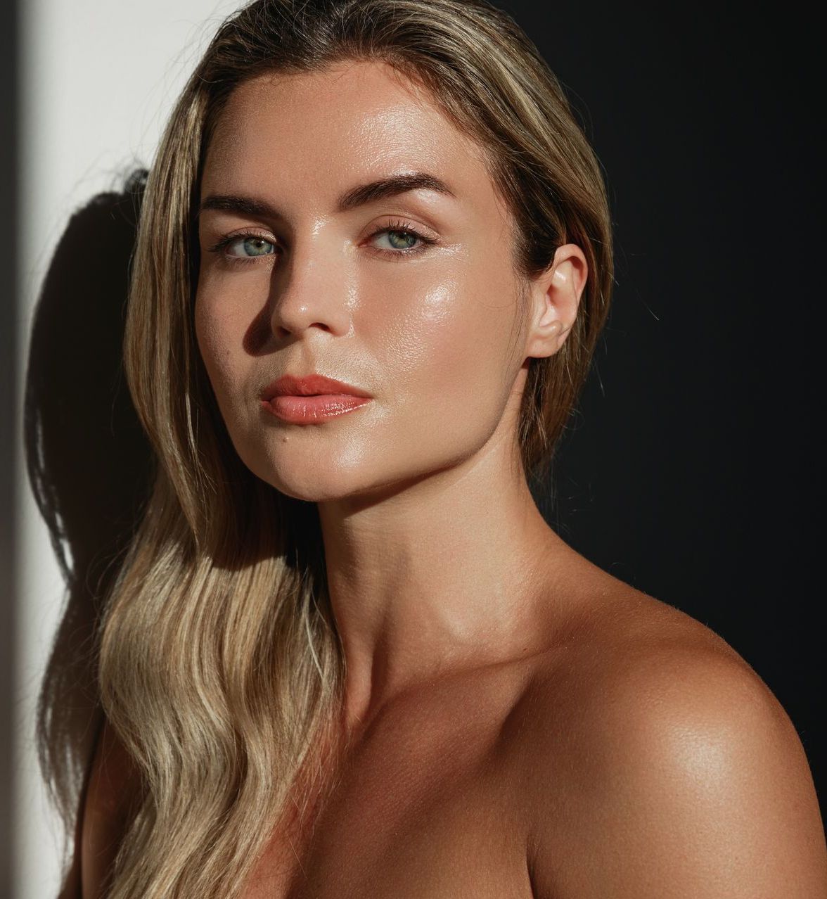 A close up of a woman 's face with a black background