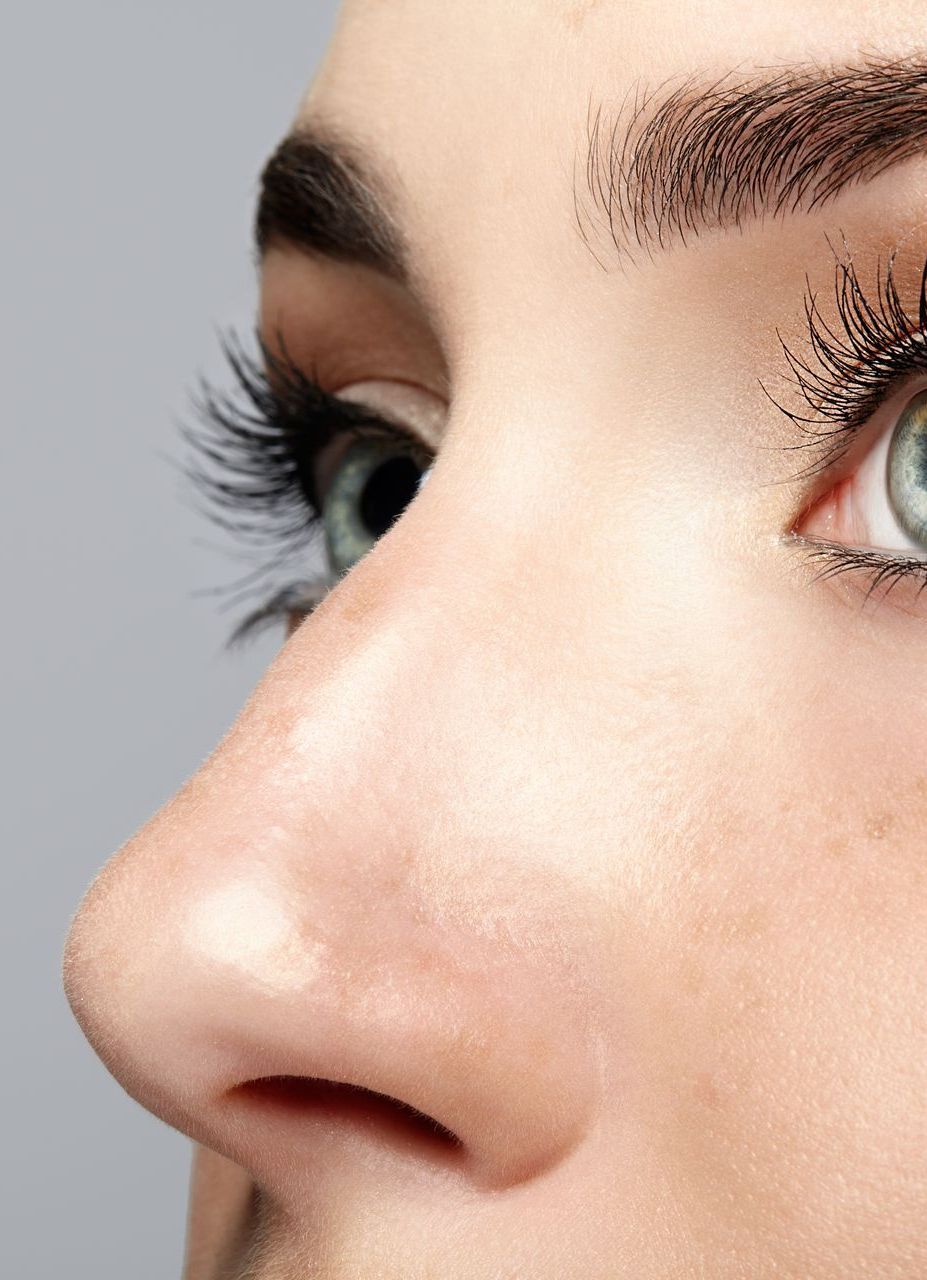 A close up of a woman 's nose and eye.