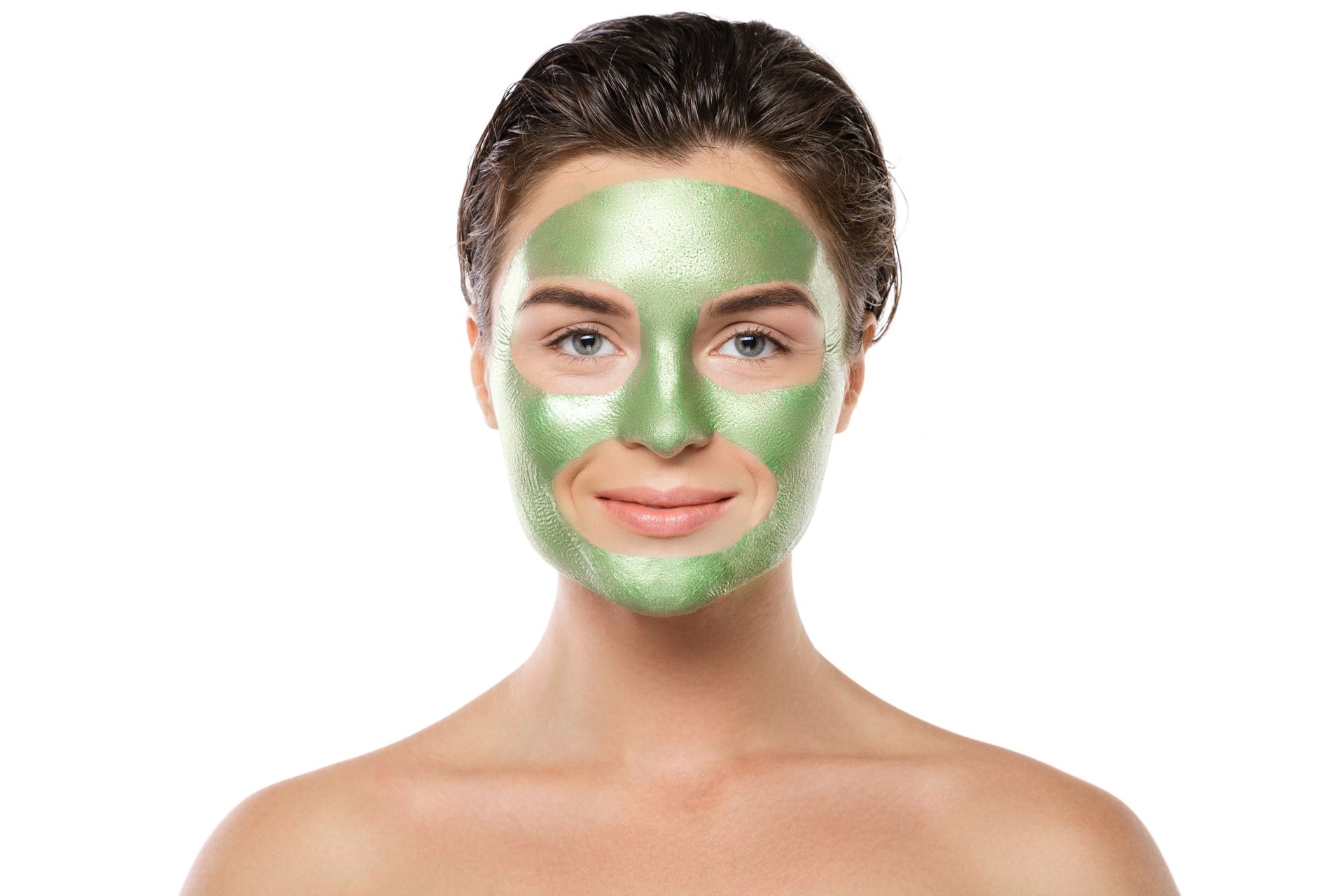 A woman is wearing a green mask on her face.