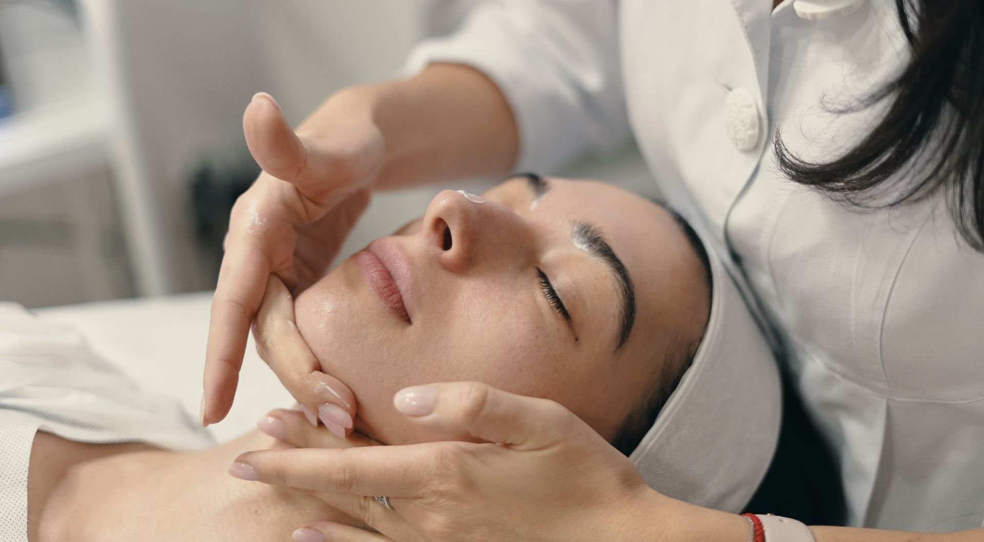 A woman is getting a facial treatment at a spa.