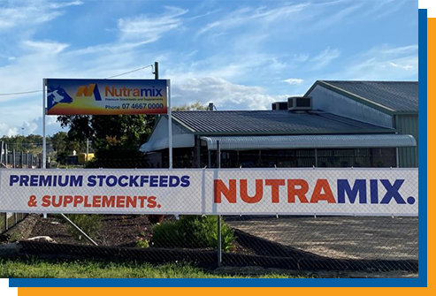 a sign for nutramix premium stockfeeds and supplements is outside of a building .