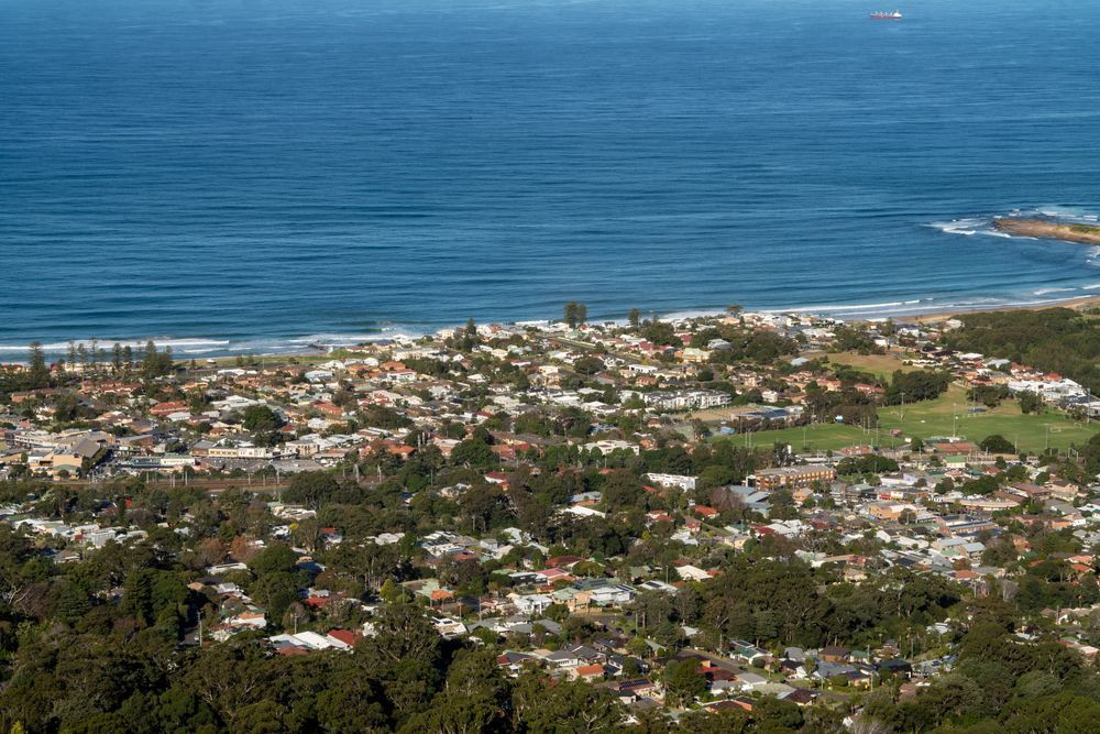 Coastal Town with Houses and Trees Overlooking a Blue Ocean — Pasiv Fire in Port Illawarra, NSW