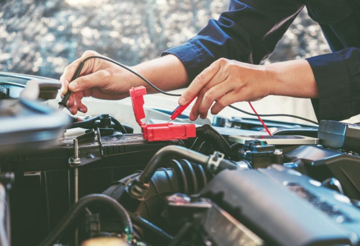 A Man Is Working On The Engine Of A Car — Ultra Mechanics In Warana, QLD
