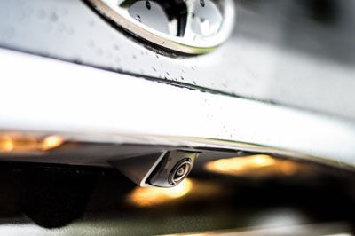 A close up of a rear view camera on the back of a car.