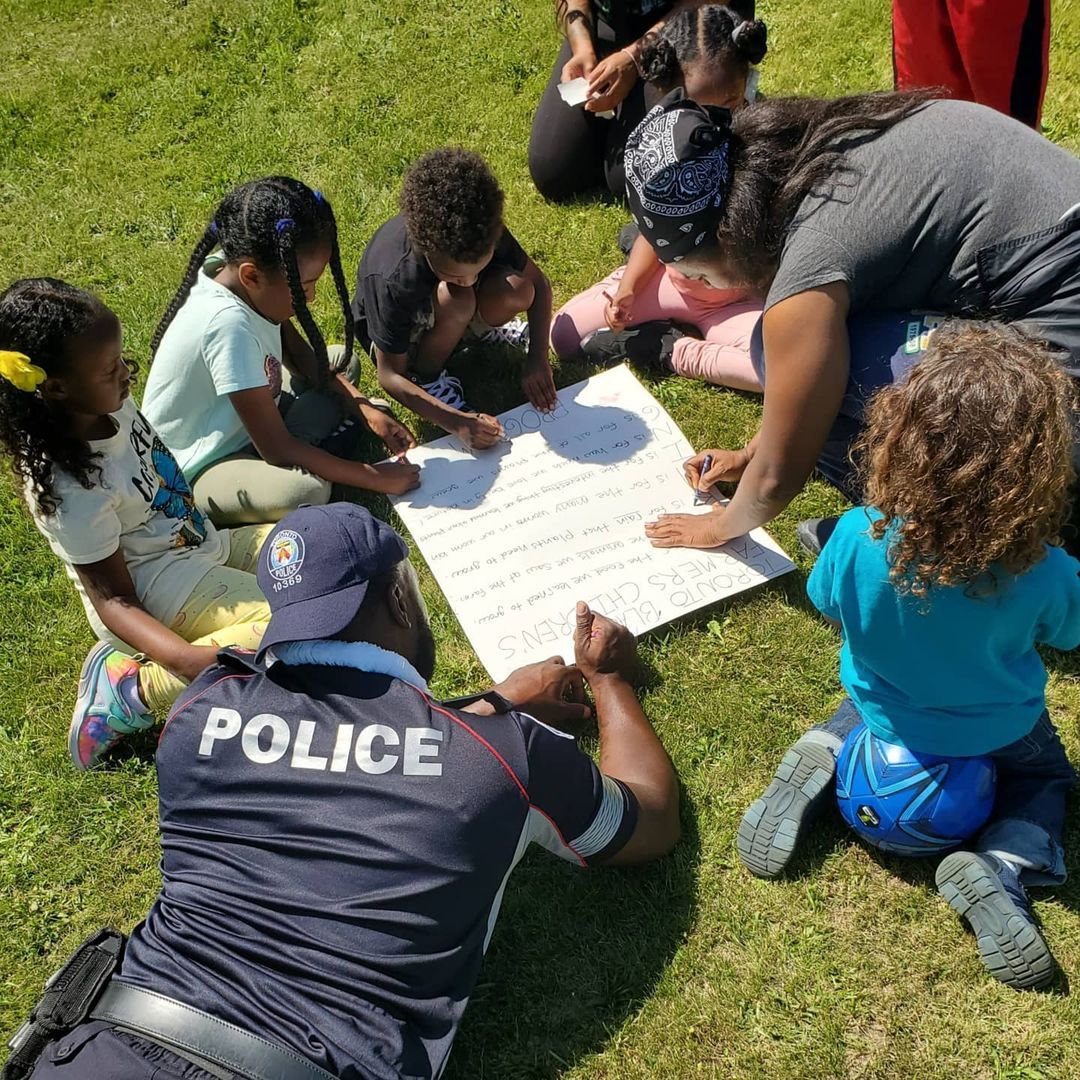 Youth drawing with a police officer