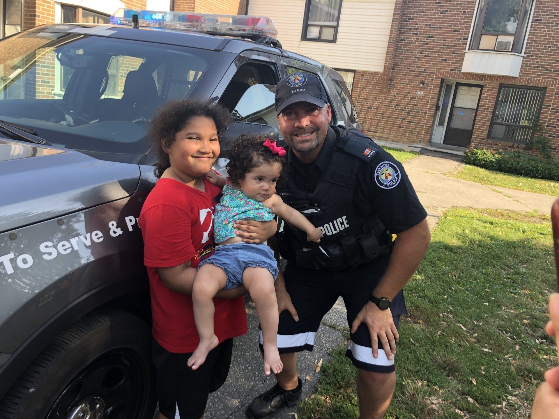 Officer taking photo with children