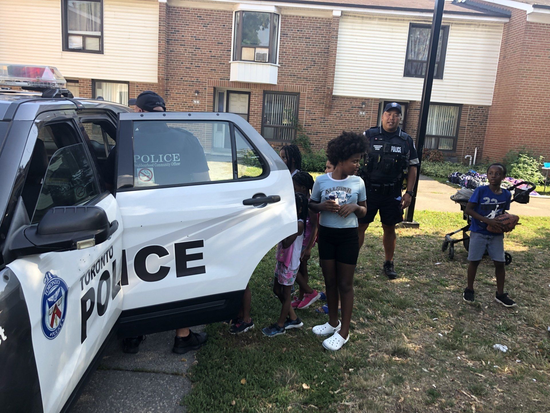 Youth looking at police vehical