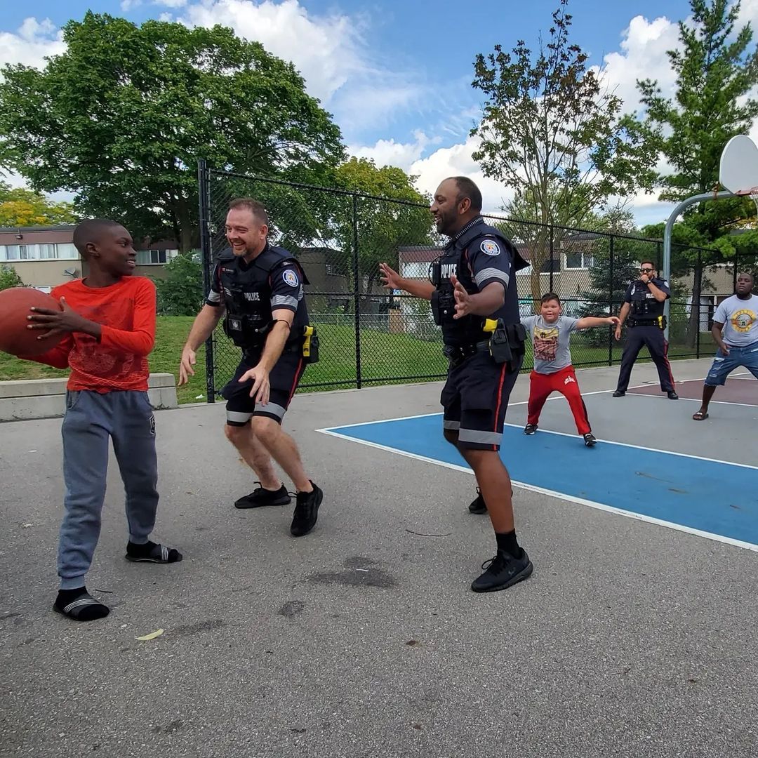 NCOs playing basketball with youth