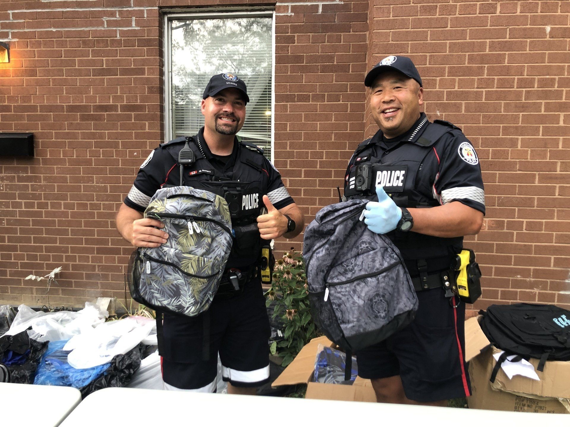 Officers holding back to school bags
