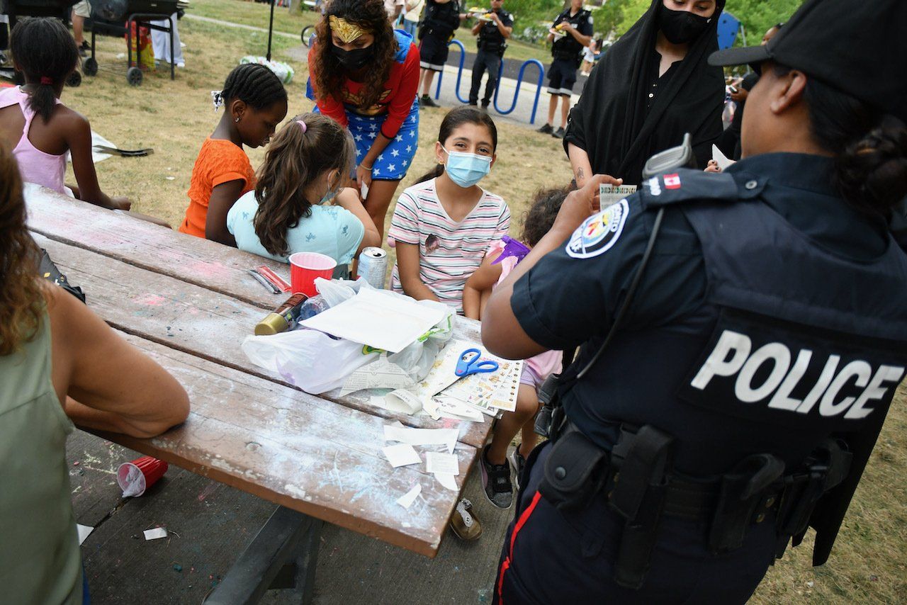 officer putting sticker on children