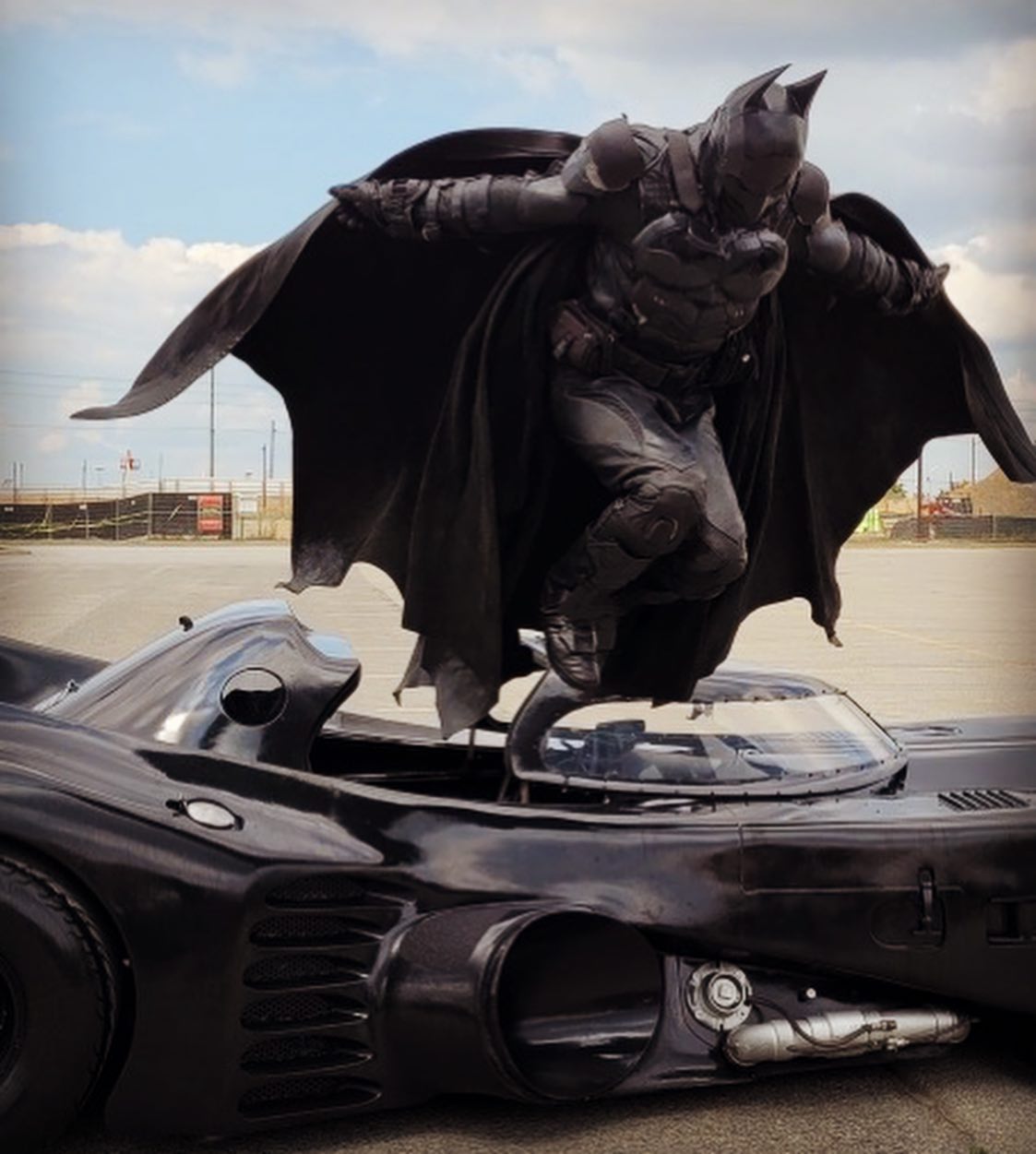 Batman jumping out of car