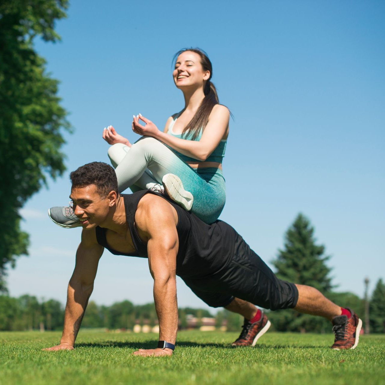 a man is doing push ups with a woman on his back