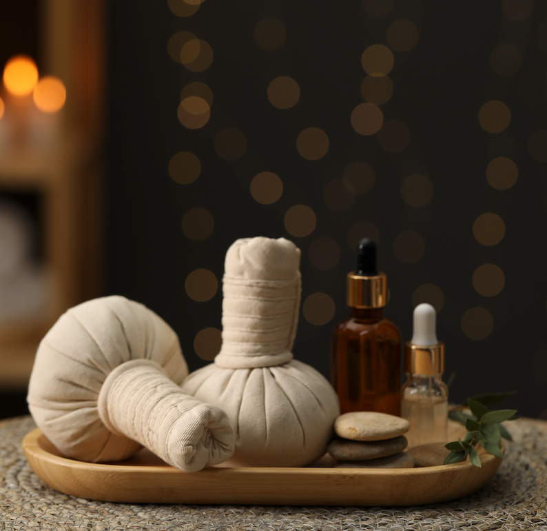 A wooden tray with a bunch of balls and bottles on it