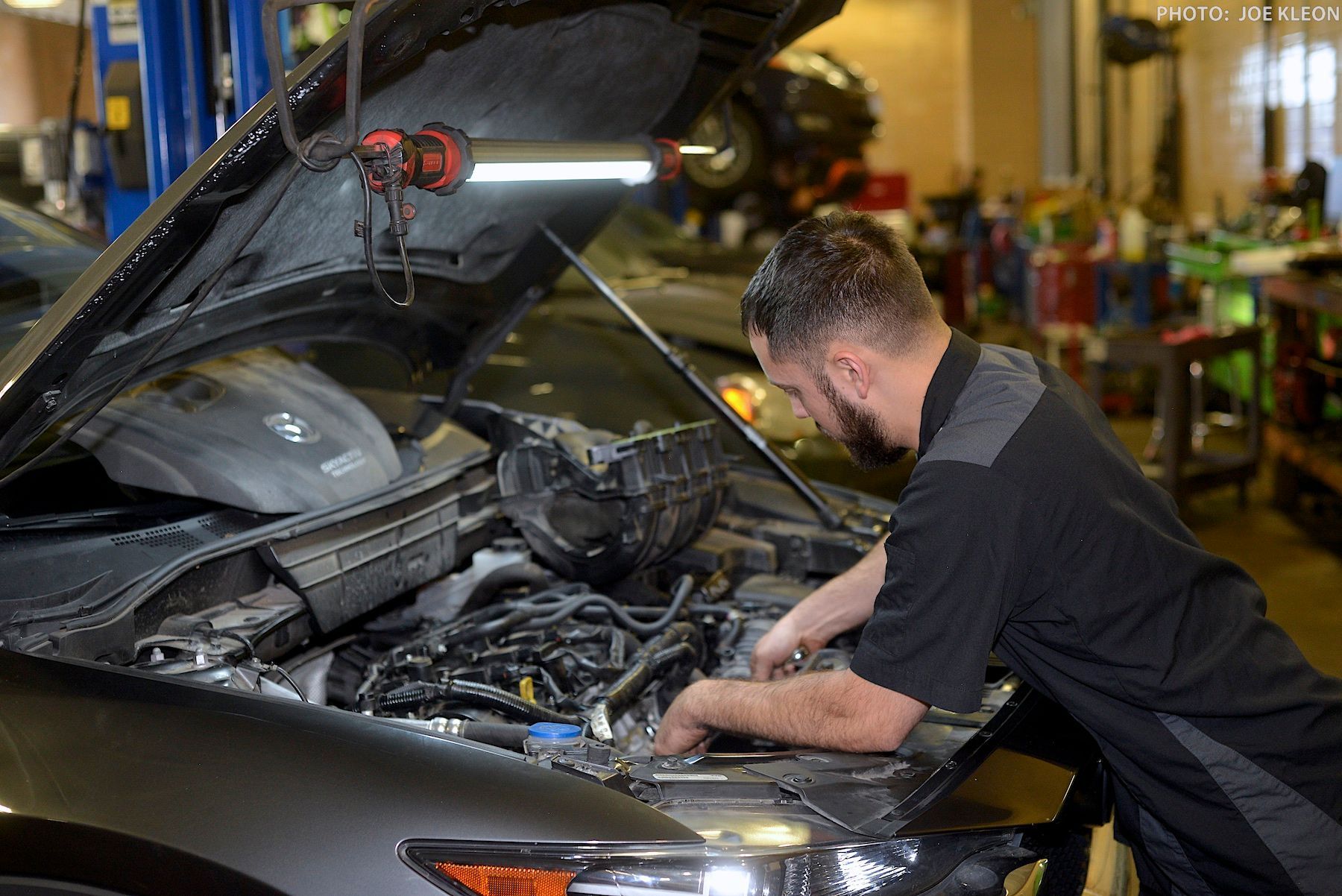 Team Member Vacuuming Rear Area of a Red SUV | Fix-it With Fred