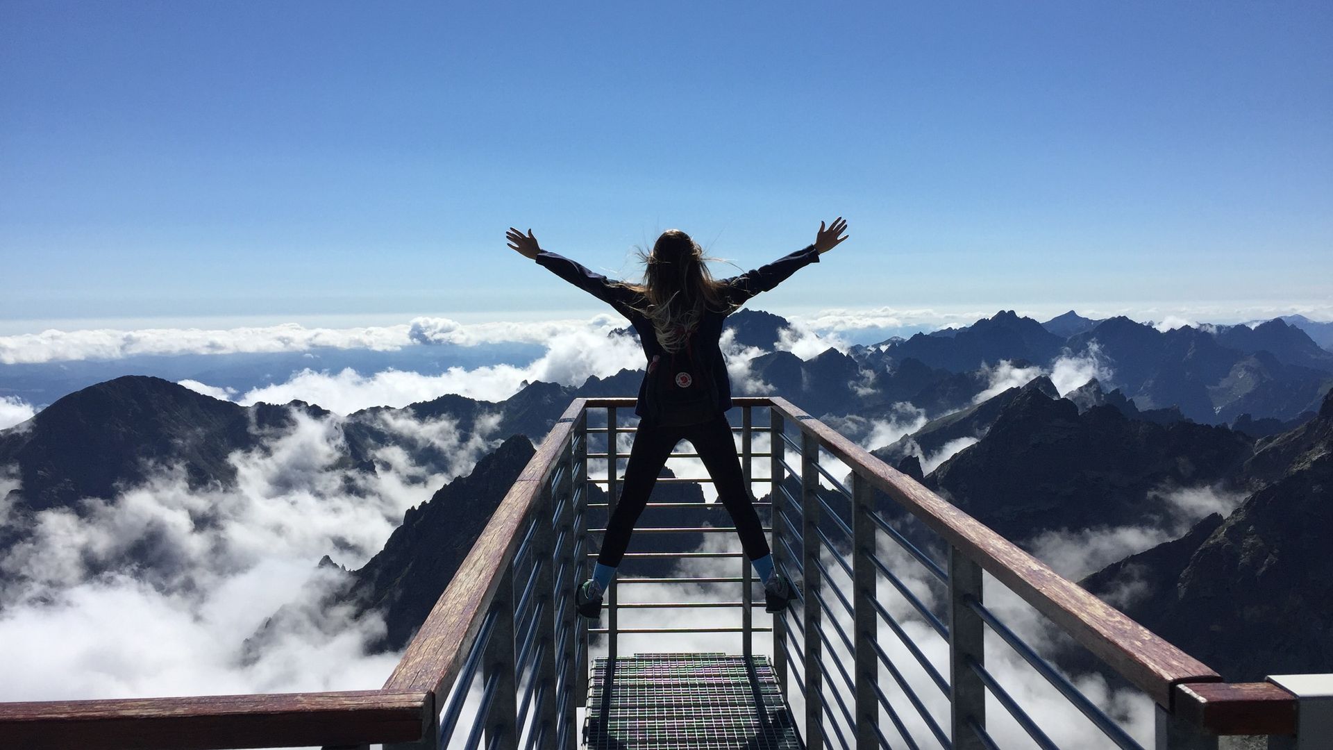 Woman empowered raising hands in the sky