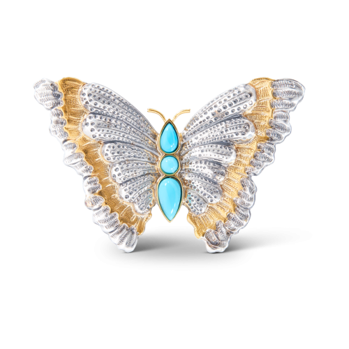 Una spilla a forma di farfalla con turchese e diamanti.