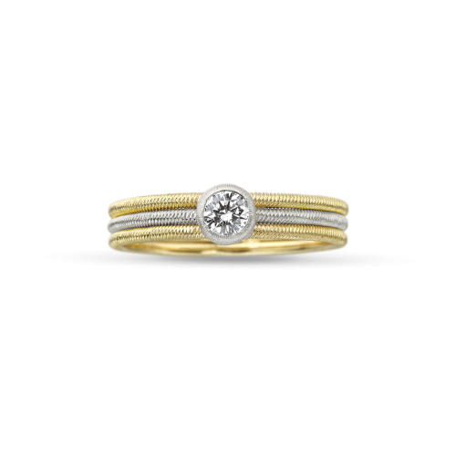 Un anello in oro giallo e bianco con un diamante al centro.