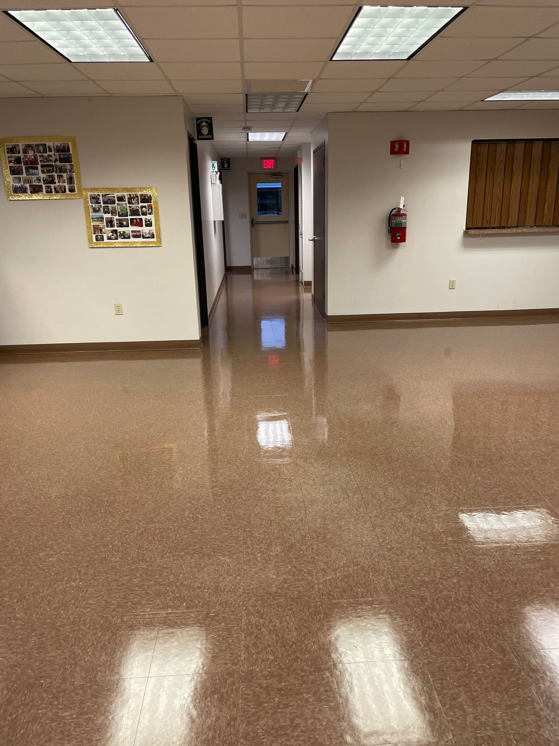 A hallway with a fire extinguisher on the wall