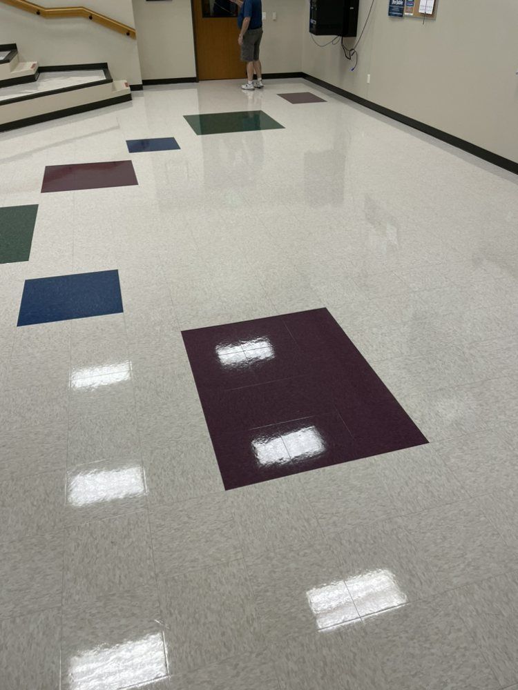A man is standing on a tiled floor in a room.