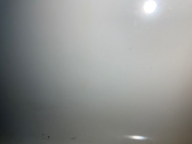 Bright light source in a gray, hazy environment.