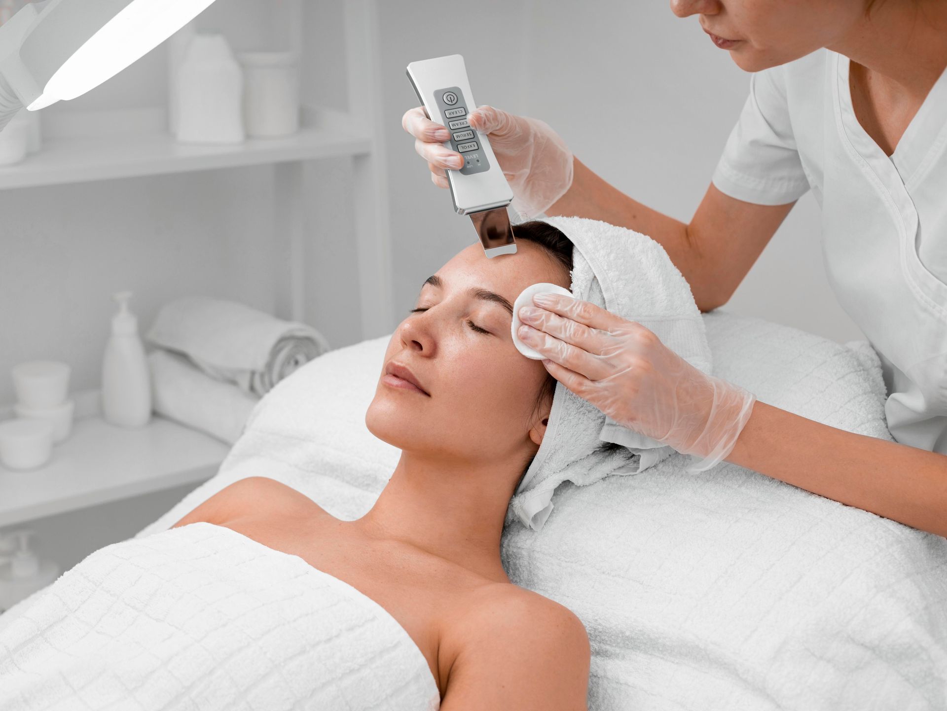 A woman is getting a facial treatment at a beauty salon.
