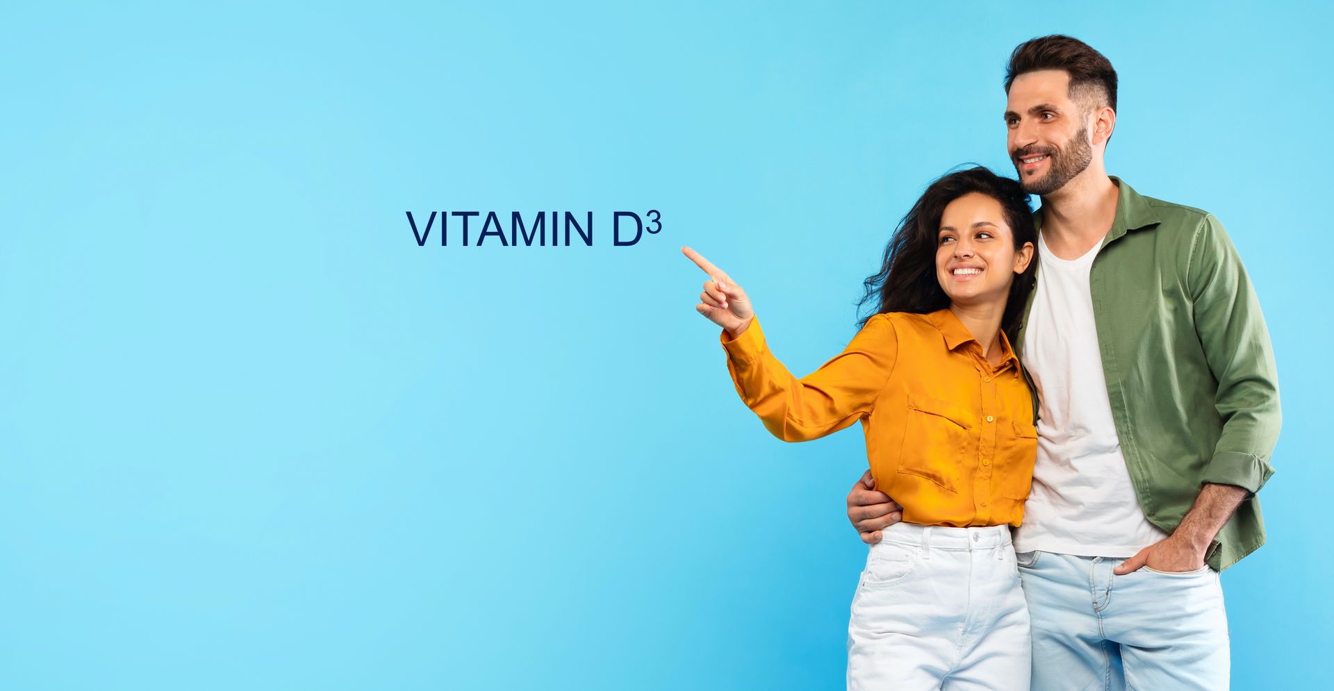A man and a woman are standing next to each other and pointing at the word vitamin d3.