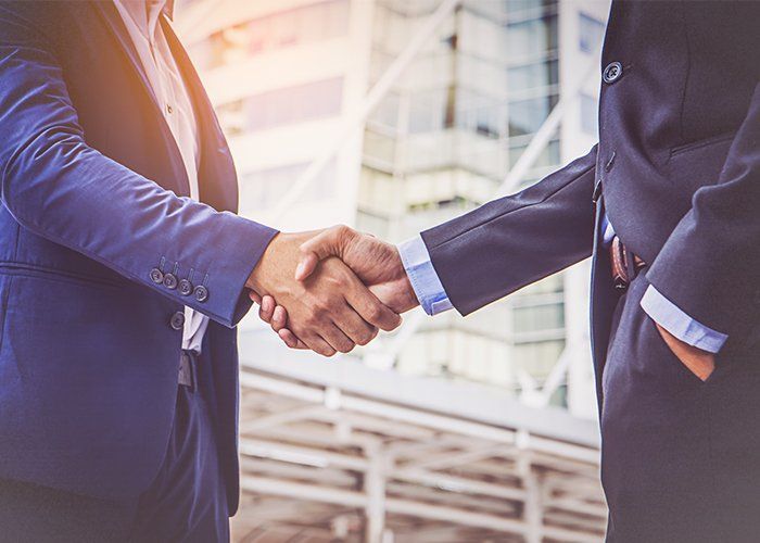 Financial Consultants — Accountant Making Handshake With Client In Treasure Coast, FL