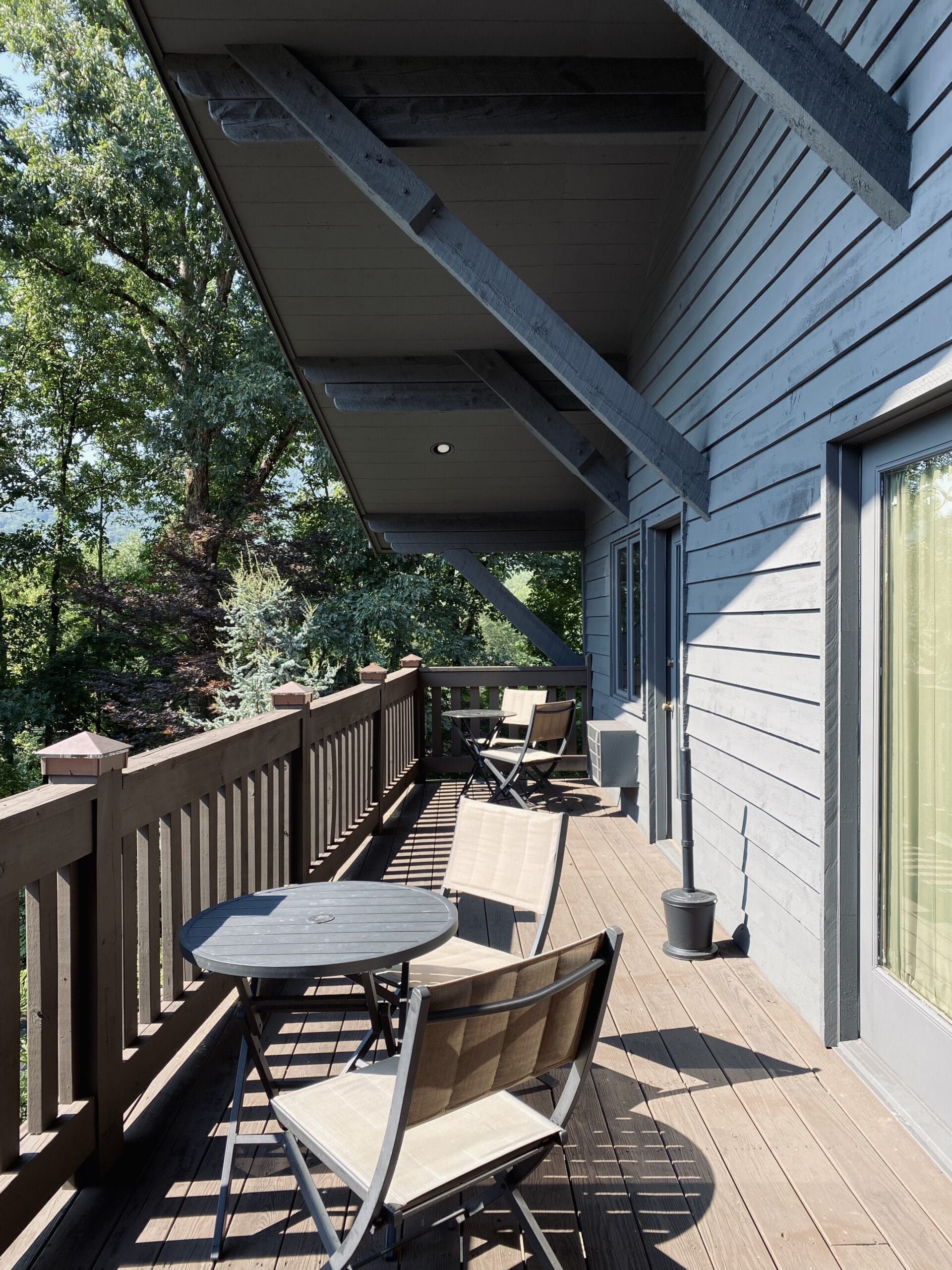 There is a large balcony with a table and chairs on it.