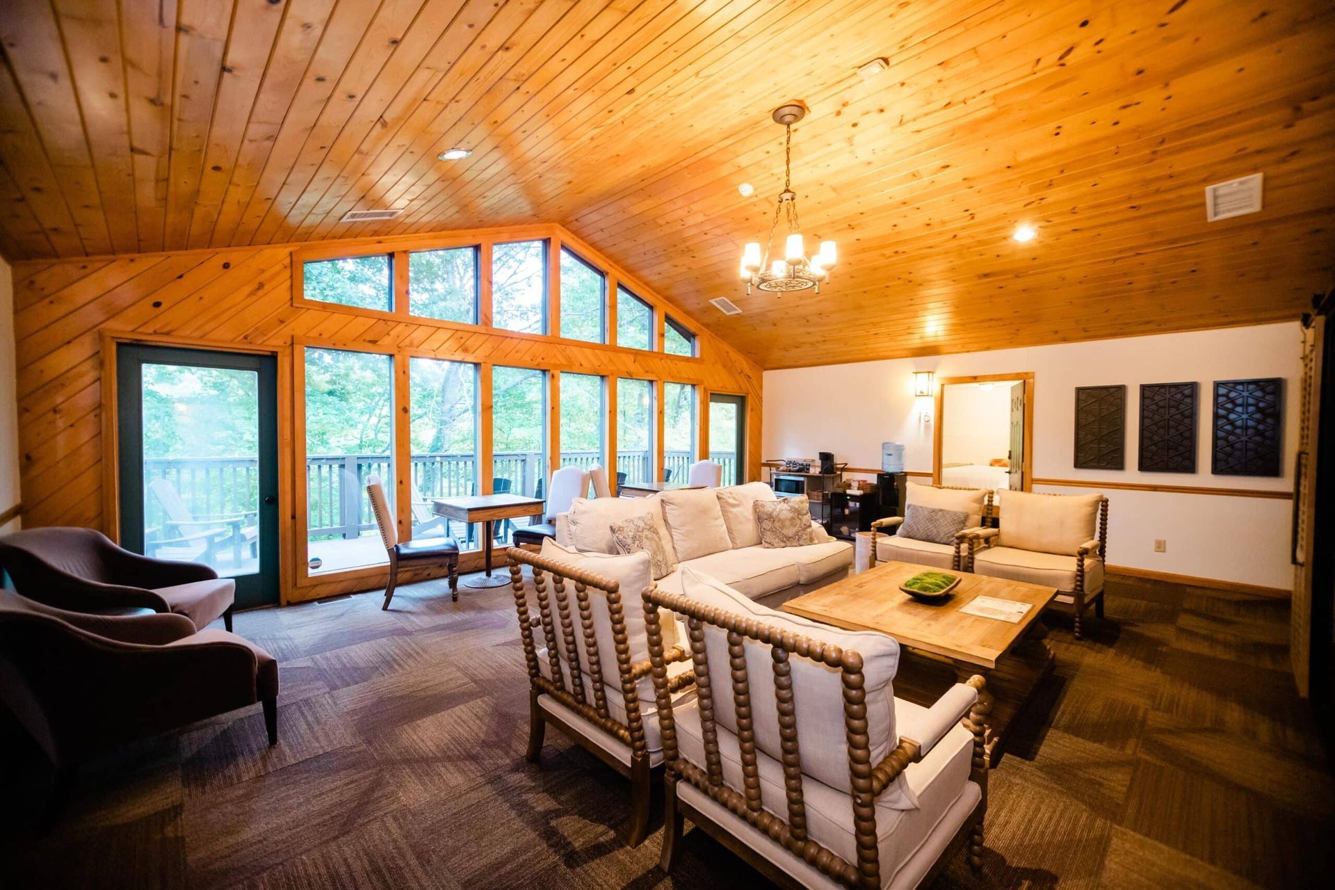 A living room with a lot of furniture and a wooden ceiling.