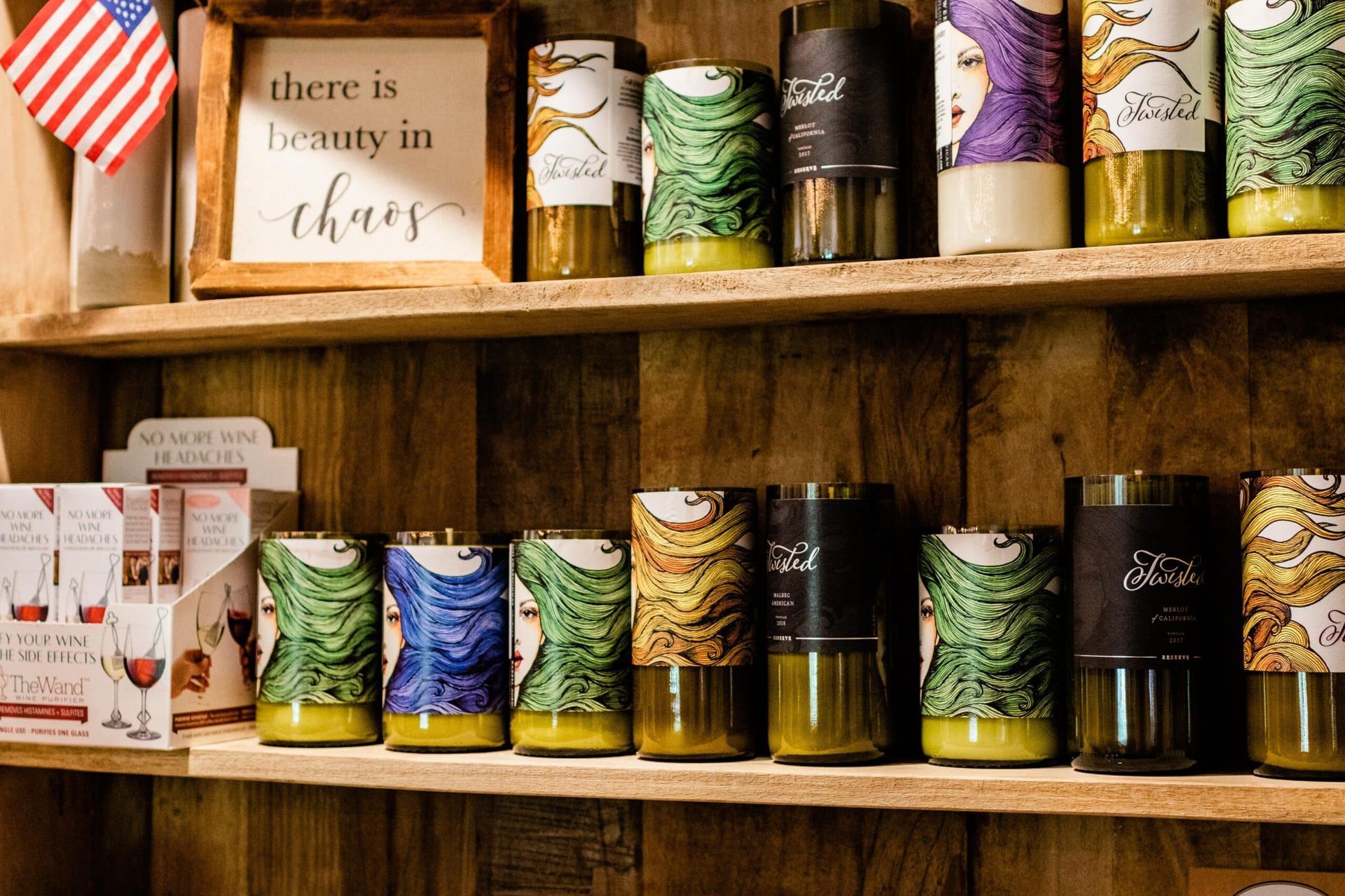 A shelf filled with candles and a sign that says `` there is beauty in chaos ''.