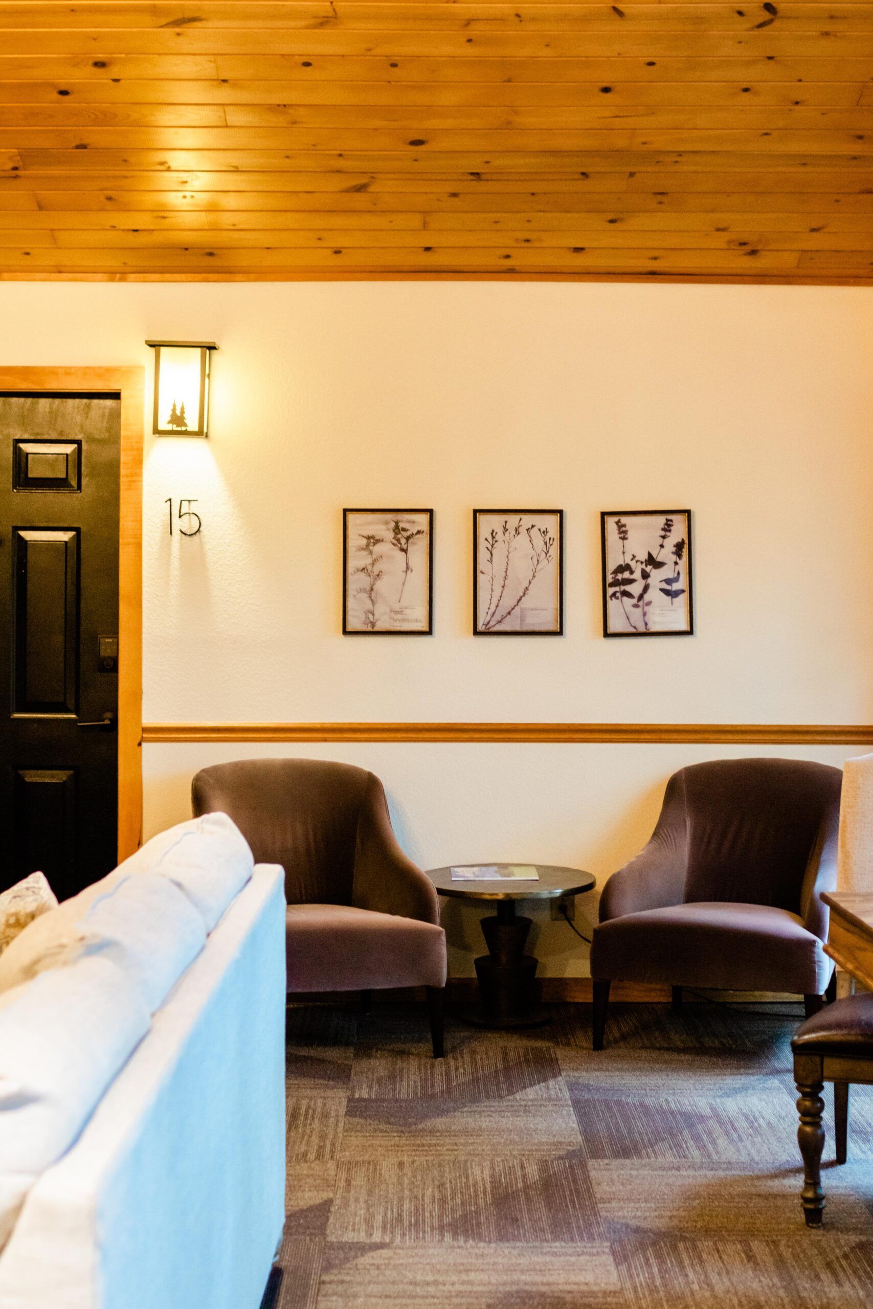 A living room with a couch , chairs , and a table.