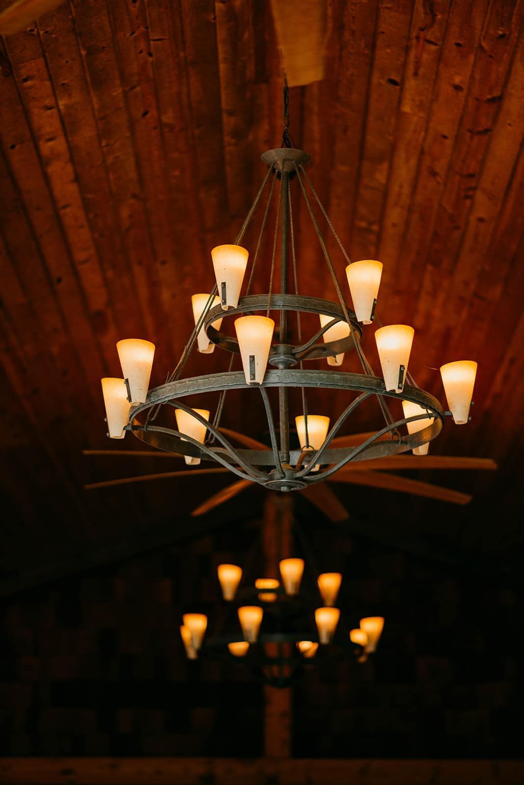 A large chandelier is hanging from the ceiling in a dark room