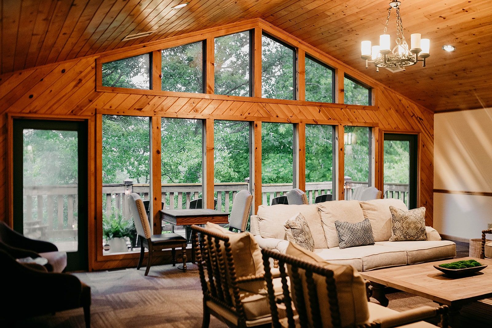 A living room filled with furniture and lots of windows.
