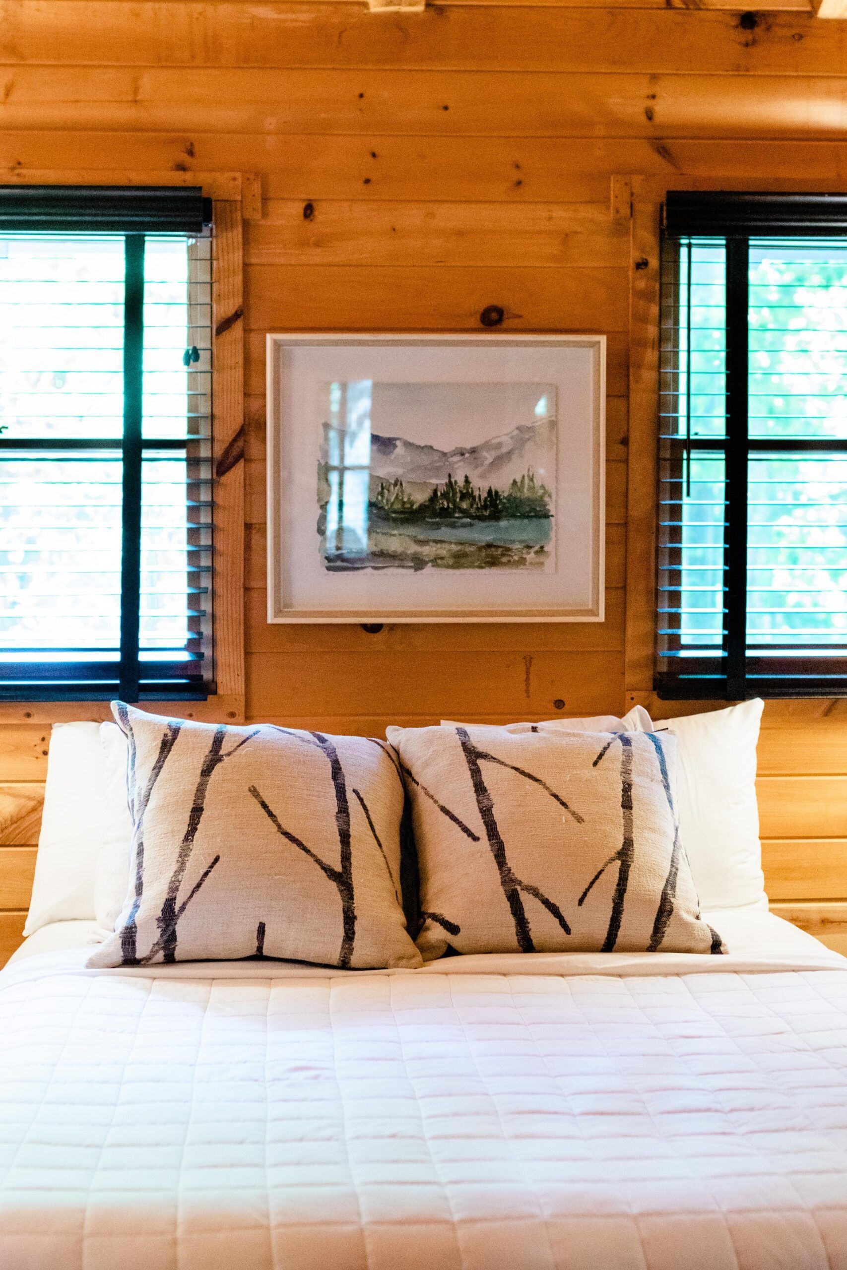 There is a picture on the wall above the bed.